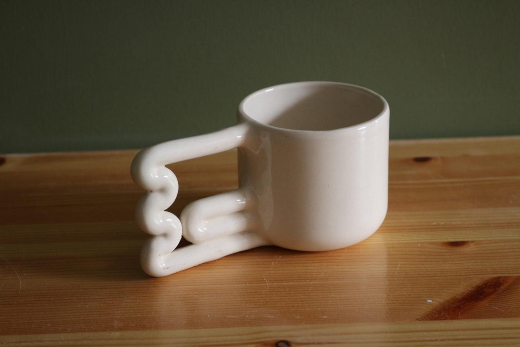 Handmade Porcelain Coffee Mug: Unique Wavy Handle, Modern Ceramic Cup