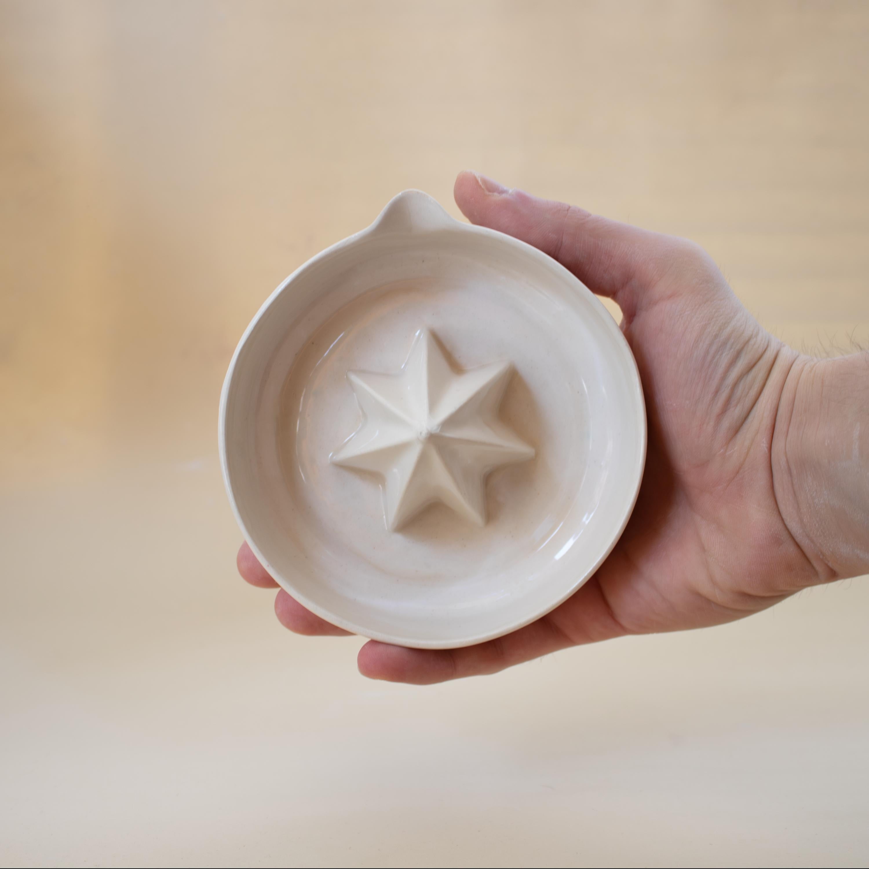 Handmade ceramic lemon squeezer with star-shaped reamer, minimalist artisan citrus juicer