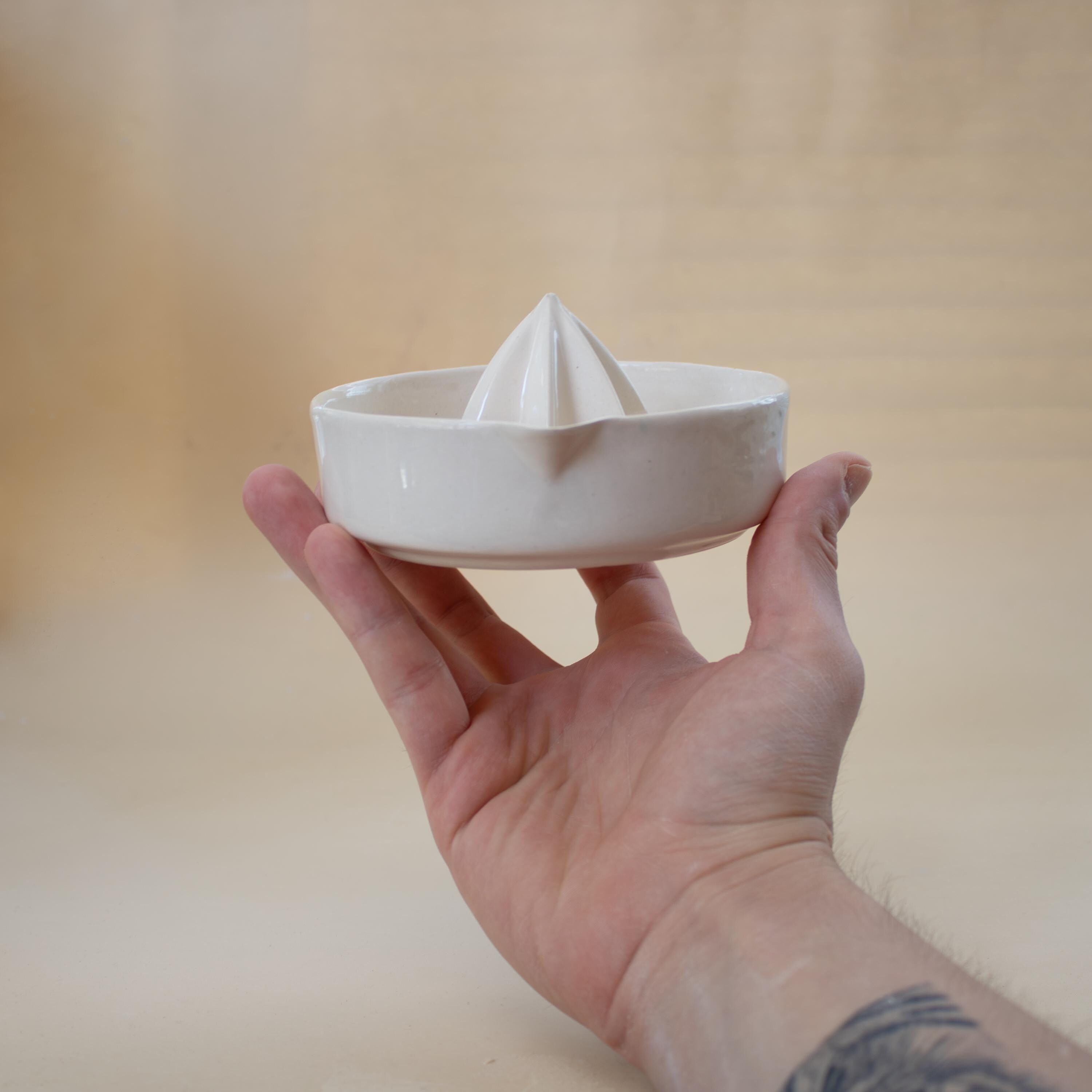 Handmade ceramic lemon squeezer with star-shaped reamer, minimalist artisan citrus juicer
