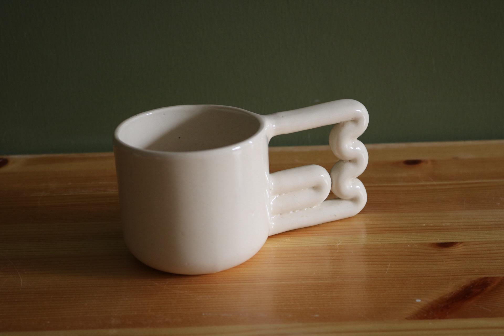 Handmade Porcelain Coffee Mug: Unique Wavy Handle, Modern Ceramic Cup